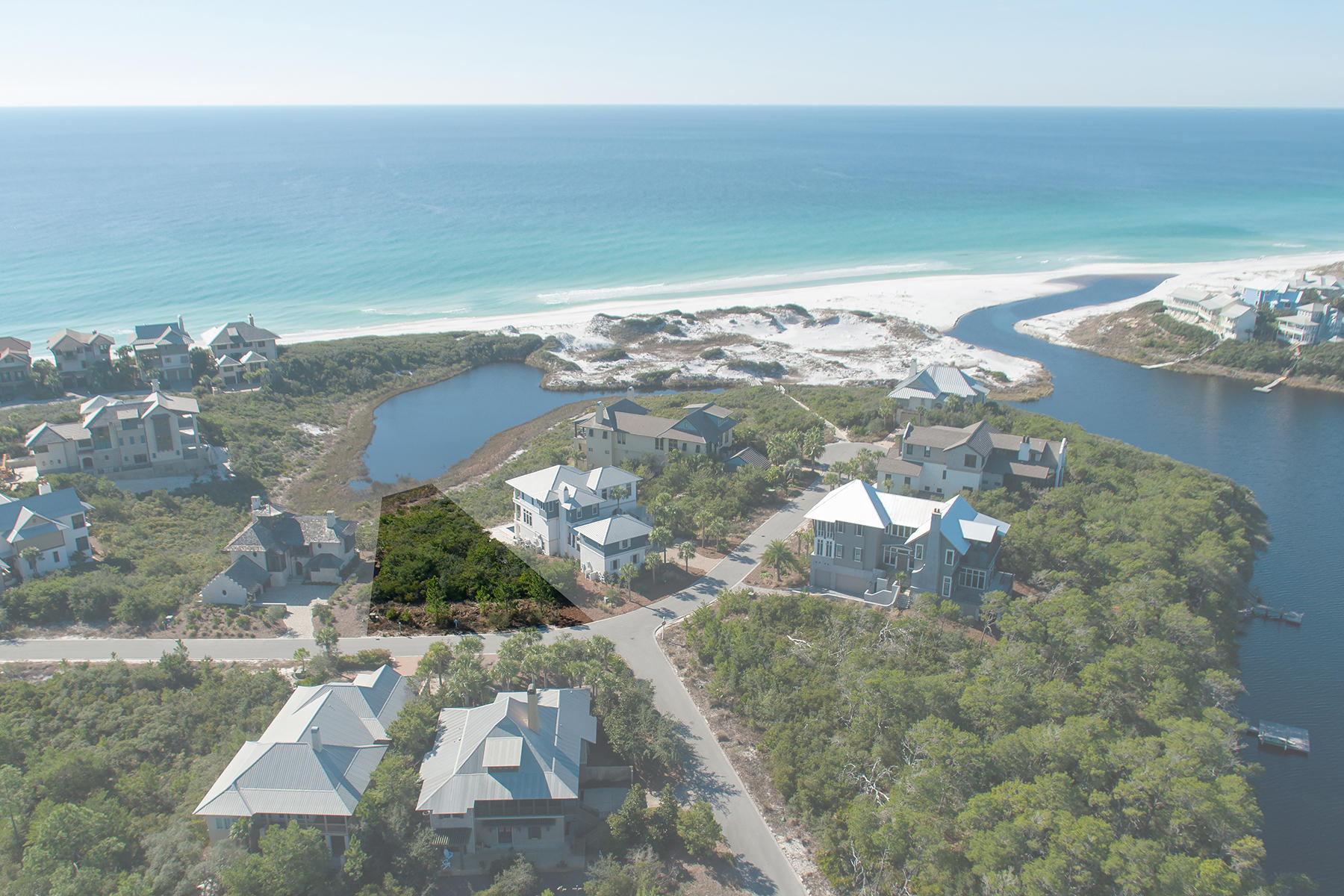 Offering a lakefront location with Gulf views, this exclusive lot in in the gated, Gulf-front neighborhood of The Retreat overlooks both Draper Lake and the Gulf of Mexico over protected dune conservation. All lots are only a short walk from the Gulf-front Beach Club with infinity edge pool. This particular lot is near the beach access on the cul-de-sac which winds through the protected dunes. There is no build-out time for this lot.