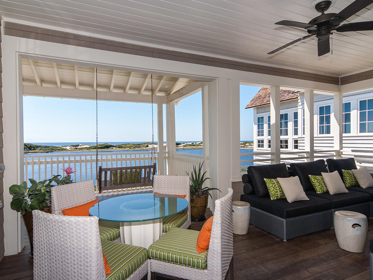 A rare coastal dune lake, protected dunes and the Gulf of Mexico layer to create a majestic, one-of-a-kind landscape that unfolds before this lakefront home in the gated, resort community of WaterSound Beach along Scenic Highway 30A in Northwest Florida. This home, designed by Elements, Tampa, Florida is built on what one could argue is the most desirable lakefront lot in Peninsula at WaterSound, situated near the point with due south orientation towards the Gulf. A brick-paved, arbor-covered path alongside the detached garage leads to the covered front porch where French doors give way to an inviting foyer where a dramatic, free-standing, spiral mahogany staircase leads to the second-floor living spaces.