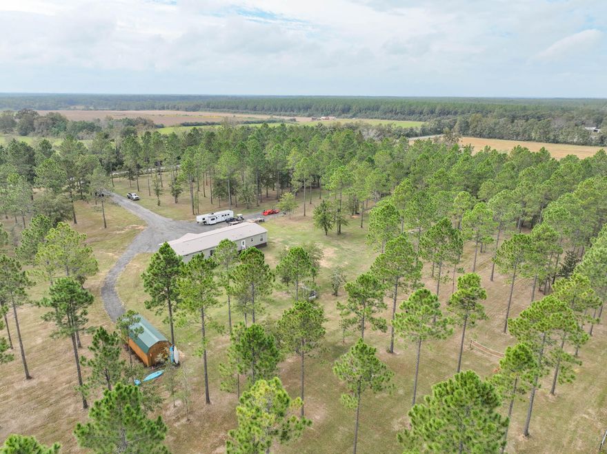 Don't miss your opportunity to own this 2020 Timberline Elite Manufactured four-bedroom home on a sprawling 21.19-acre homestead.  Experience the peace of idyllic living with nature while enjoying the Fox squirrels, deer and various birds that roam the property.  Launch into an  adventure and enjoy the back 10 acres composed of custom ATV trails.  For the foodie, there is a large chef's kitchen with an oversized double door refrigerator, granite counter tops, apron sink, double ovens and large island for preparing meals with plenty of room for seamlessly entertaining.  A barn, stable, pasture, pool, trampoline, or whatever you fancy can be added while still leaving ample room.  For your storage solutions, there is a large, detached workshop with a loft.  Buyer to verify all information