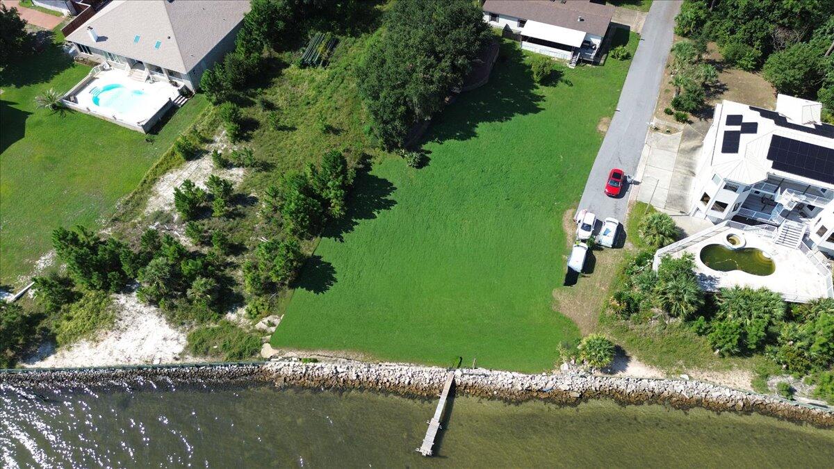 Endless Possibilities Await! Nestled on a waterfront lot this property offers the perfect opportunity to bring your vision to life. Currently home to an as-is single family residence, the true value lies in the blank canvas waiting your dream build. Whether you envision a custom estate, a modern farmhouse or a peaceful retreat surrounded by nature, this address is where future plans take root. Enjoy the freedom with no HOA to design a home that fits your lifestyle while appreciating 100 ft of waterfront potential. Imagine morning coffee with these water views or sunset gatherings with friends and family. Boating, kayaking and paddle boarding right out your door, you might even see dolphins and sea turtles! Conveniently located off HWY98 close to shops, dining, schools and sandy beaches. The 1983 single family residence is being sold AS IS. The home is livable, yet the intention is to sell the land with the potential it offers future buyer/s.
Please see the document section for floor plan example and supporting docs.