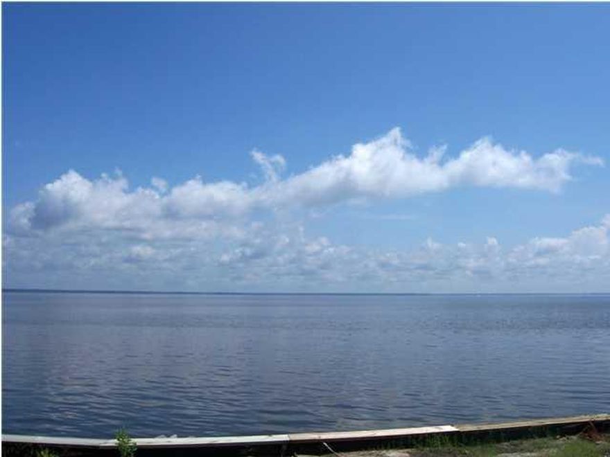 Gorgeous bay front homesite with 100 feet on the bay. Deep wooded lot, seawall and rip rap in place. Beautiful bay front homes in this neighborhood, paved roads