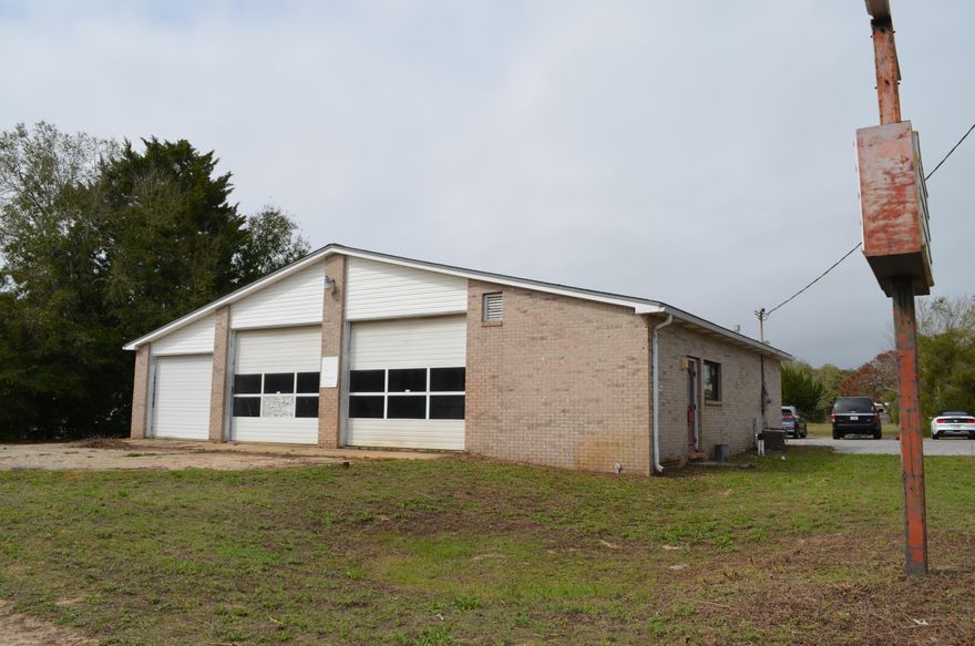 This property has great visibility right on Highway 98 and has a wide range of options for your business needs. Thriving businesses right across the street on Ranger Road. Building was previously an oil change/ service shop. There is a waiting room/ lobby, two restrooms, a private office, and large open areas with garage doors. There are some above ground tank reservoirs on the lower level of the property, property is being sold As Is.