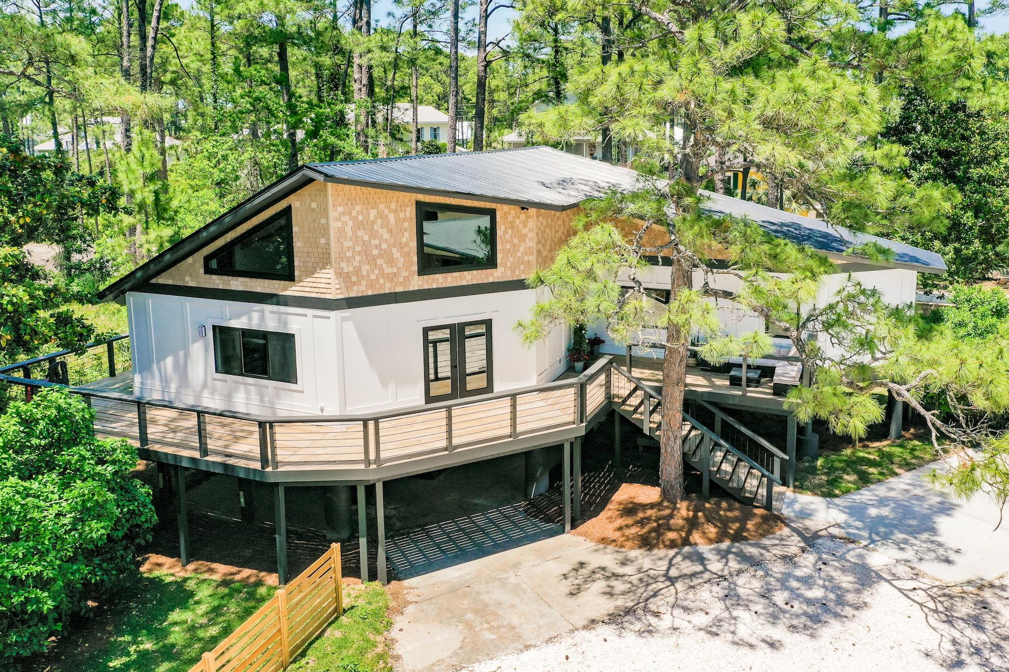 Located in the heart of Dune Allen, this post and beam construction home features lake and gulf views! Three bedrooms and three full bathrooms with turnkey contemporary beach house style. Enjoy dual master suites, spacious bedrooms and closets as well as a kitchen with a large double farm sink, a custom island and pantry. This home boasts large, exposed cypress beam construction throughout and soaring ceilings in the main living spaces. Additionally, this beach home offers various updates including a new HVAC system, new roof and new windows/doors. Families can enjoy the home's rare, spacious, fenced-in yard perfect for children and dogs to play! With a picturesque location nestled on a secluded lot overlooking Oyster lake,30A and the white sand beaches,this home is an absolute must-see.