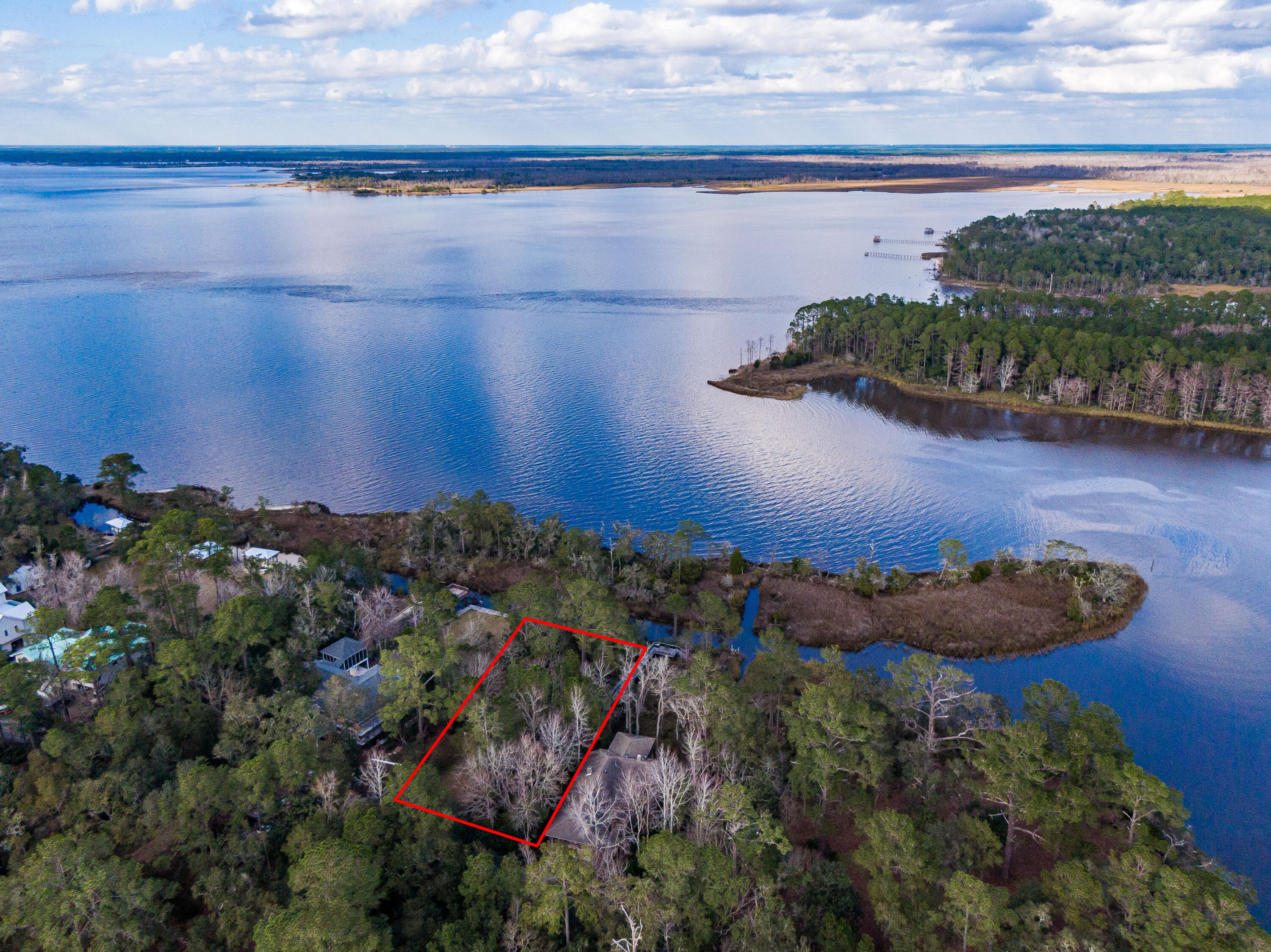 Welcome to The Shallows, Point Washington's impressive eastern most waterfront neighborhood. Ideal location to build the home of your dreams with picturesque views of the Choctawhatchee Bay and Tucker Bayou. This oversized, half acre, canal front homesite is partially cleared and sits among towering Oak and Magnolia trees. Direct bay and bayou access and minutes to 30A, Grayton Beach and the Gulf of Mexico. Surround yourself with nature, boating, fishing, paddle boarding, beaching, sunning, shopping and dining. All accessible from this enchanting setting.