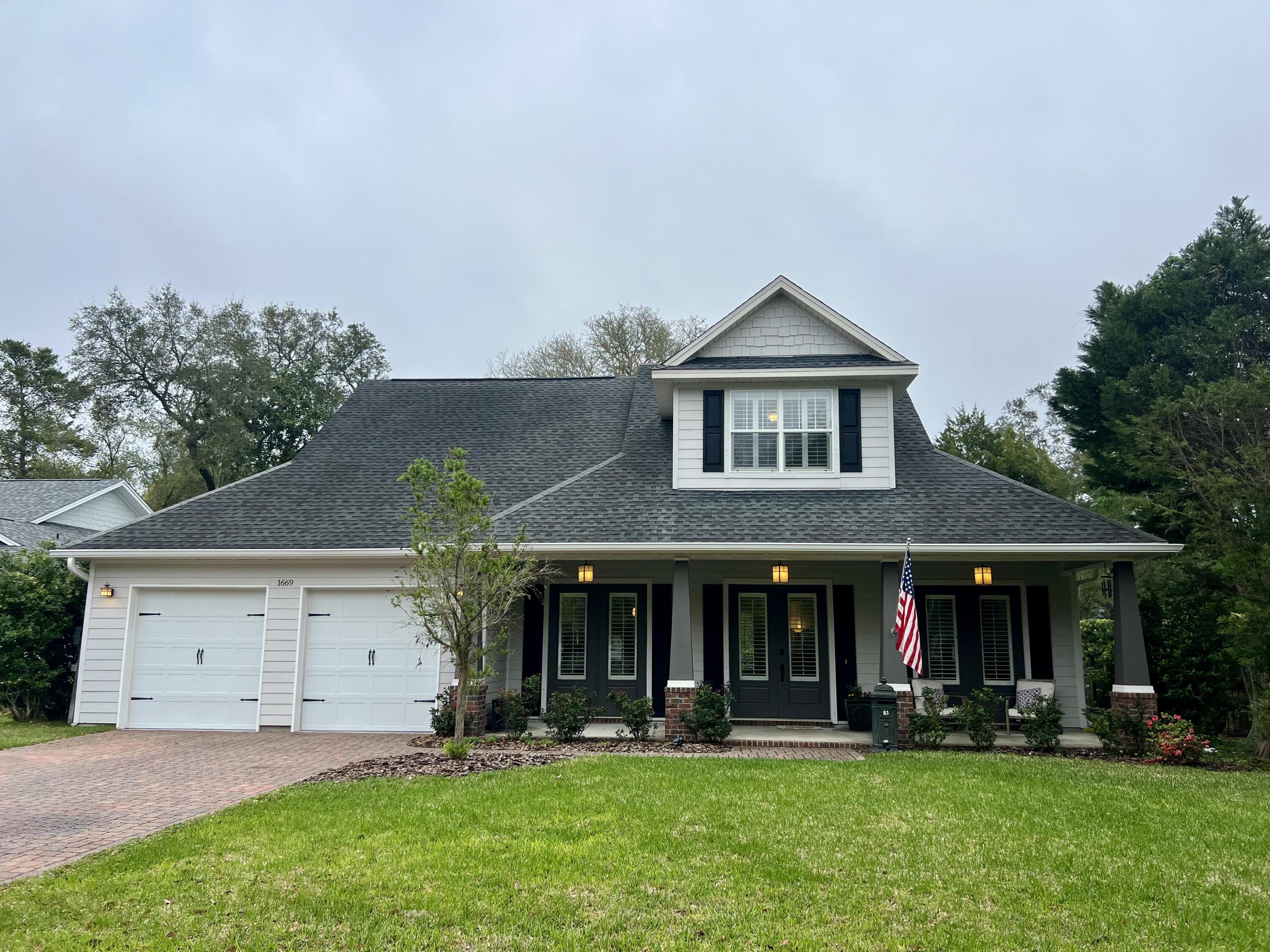 This charming 4-bedroom, 4-bath home is nestled in a picturesque neighborhood with pavered streets and majestic oak trees draped in Spanish moss. The primary suite is conveniently located on the main floor, along with a guest bedroom and full bath. Just off the primary suite, a recently enclosed exterior porch now serves as an office, but it could easily be transformed into a workout room, playroom, or sunroom. The open-concept living area features a stunning gas fireplace and built-in shelving for added storage. The kitchen has been tastefully updated with granite countertops and an apron-front sink. Upstairs, both bedrooms offer private en suite baths and walk-in closets. At the top of the stairs, a versatile flex space is currently set up as a recreation area with a sofa and TV. The backyard is fully fenced and features fresh new sod.
