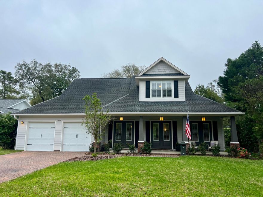 This charming 4-bedroom, 4-bath home is nestled in a picturesque neighborhood with pavered streets and majestic oak trees draped in Spanish moss. The primary suite is conveniently located on the main floor, along with a guest bedroom and full bath. Just off the primary suite, a recently enclosed exterior porch now serves as an office, but it could easily be transformed into a workout room, playroom, or sunroom. The open-concept living area features a stunning gas fireplace and built-in shelving for added storage. The kitchen has been tastefully updated with granite countertops and an apron-front sink. Upstairs, both bedrooms offer private en suite baths and walk-in closets. At the top of the stairs, a versatile flex space is currently set up as a recreation area with a sofa and TV. The backyard is fully fenced and features fresh new sod.
