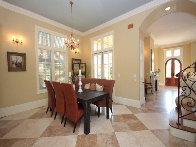 Gated neighborhood of Caribe is on the beach and this home is a short stroll down the sidewalk to the community pool and Gulf! Custom designed by Christ & Associates, this Mediterranean Home features a wraparound front porch with stone columns, exposed beams, and outdoor fireplace. Through the arches, pass through the double mahogany door entry to a light-filled, 12-foot tall great room with fireplace, built-in media cabinet, and fine mill work. Travertine throughout downstairs and hardwood upstairs. Enter the formal dining room on the way to an additional great room with chef's kitchen at the rear of the home overlooking a courtyard with hedged fountain. A detached guest house shares access to this outdoor retreat.