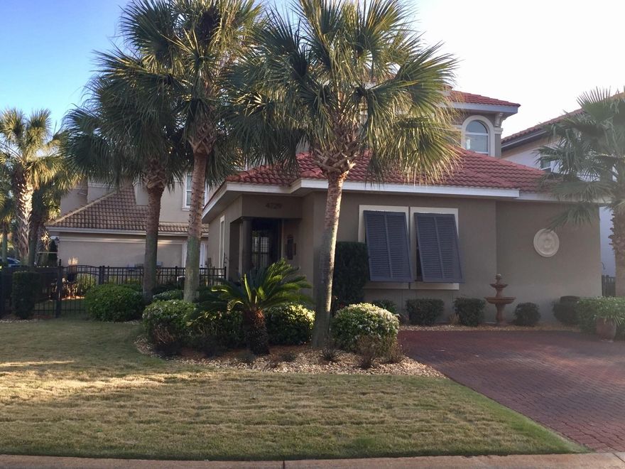 Beautifully decorated and maintained home in a gated community. Fine finishes throughout this home including upgraded light fixtures, stainless appliances, granite, crown molding, high ceilings, ornate iron railing, new all wood decorative corbells, bahama shutters, hurricane shutters, brick paver driveway and walkways. Incredible landscaping with new sod. Master bedroom is downstairs with luxurious master bath featuring a whirlpool tub and walk in shower, and the two upstairs bedrooms share a balcony overlooking the yard. This home has a large corner lot with upgraded iron fencing and lovely landscaping. HVAC replaced 9/2015. Exterior painted June 2013