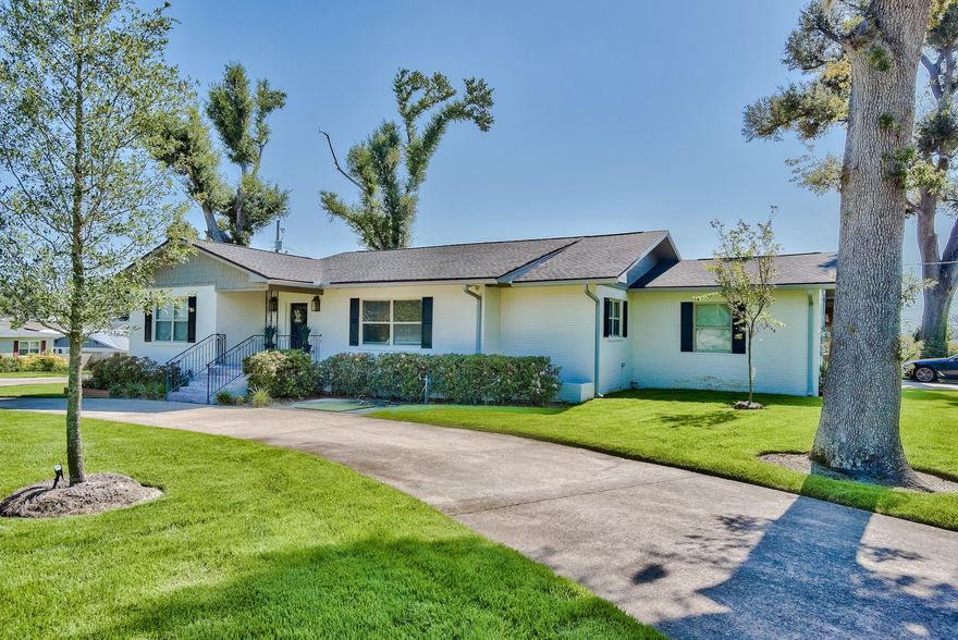 BACK ON THE MARKET! Located in the heart of the Cove beneath hundred year oaks, you'll find a completed renovated home with high end luxury finishes. Located on an oversized, manicured lot, this desirable neighborhood is where you'll want to be for years to come. This home offers light, bright, luxury vinyl plank flooring throughout, three bedrooms, two bathrooms and a bonus room for work or play. The open concept is incredible for entertaining with a custom designed, oversized island, GE Cafe appliances and a Hallman 60-in 8-burner, dual-fuel Italian range. Bathrooms with modern finishes and a tiled shower with dual heads and a custom vanity which create the ideal master suite. Ample storage inside, a two-car attached carport and shop/storage.