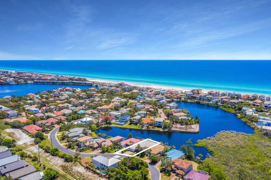 Prominent lake front positioning paired with an expansive single level floorplan solidifies this charming beachside villa perfectly poised within the gated enclave of Destiny S/D. Notable features include three sizable bedroom suites with an additional fourth media / potential bedroom space as well as impressive 12' ceilings throughout the home yielding an open floor-plan that takes full advantage of the south facing lake frontage. The central living area is comprised of a fabulous chef's kitchen which offers finely appointed finishes including custom cabinetry, professional appliances and is open to the dining area, living room with fireplace and wet bar as well as direct access to the lakefront screened lanai.