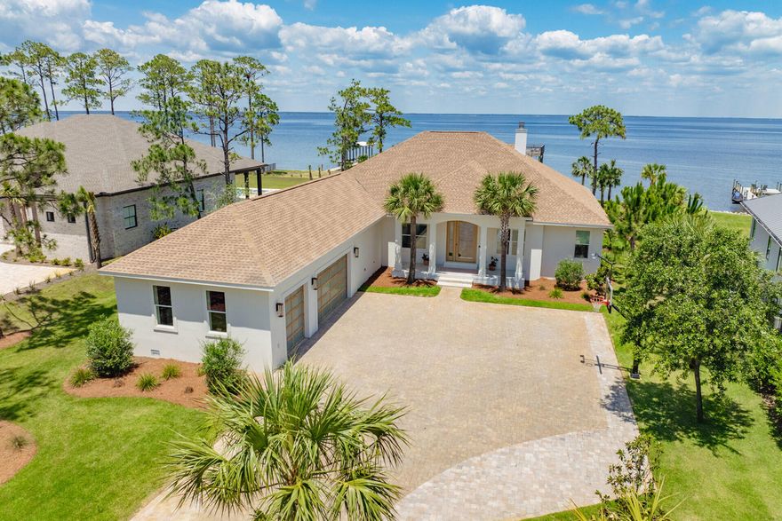 Introducing a one-of-a-kind bayfront masterpiece at 1341 Driftwood Point Road in Santa Rosa Beach, Florida -- where modern design meets effortless luxury. Completely revamped with over $1M in high-end updates, this stunning retreat sits on 0.87 acres with 110 feet of private frontage on the Choctawhatchee Bay. Enjoy endless water views, vibrant sunsets, and true indoor-outdoor living with six sets of expansive sliders that open to the bay. At the heart of the property is an oversized private pool and spa surrounded by a paver sundeck, loungers, and outdoor dining. White oak flooring, artisan clay tile, and abundant natural light create a serene, elevated atmosphere throughout the home. Inside, the residence offers four bedrooms, three full bathrooms, a private office with custom glass-and-brass partition doors, and a media room anchored by a striking white oak feature wall. The kitchen is a showpiececentered around a massive 5' x 12' quartzite island and complemented by custom white oak shelving, all-new cabinetry, and a premium side-by-side refrigerator and freezer. Additional interior highlights include oversized primary closets, floating vanities, a designer mudroom, and a beautifully appointed laundry space.

Nearly every detail has been thoughtfully elevated to create a move-in-ready experiencetwo HVAC units, a whole-home Generac generator, custom garage doors, gas lanterns, spray-foam insulation, and a newly installed seawall add comfort, efficiency, and long-term peace of mind. The double-decker Trex dock with boat lift and the three-car garage with 13-foot ceilings offer exceptional convenience and storage for coastal living.

Perfectly positioned just minutes from the world's best beaches, premier dining, boutique shopping, and top-rated schools, this rare bayfront offering blends privacy, luxury, and location into one unforgettable lifestyle opportunity.