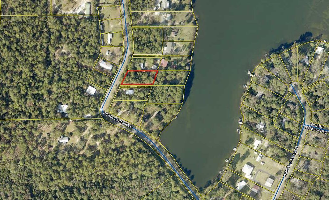 ALMOST A HALF ACRE NEAR KING LAKE -- This level wooded lot would make a great homesite for either a mobile home, a modular home or a site-built home. Located on a paved road near beautiful King Lake, there is City Water and electric available at the street. Tap fee is due. A septic tank would need to be installed on the lot. All dimensions and acreage to be verified by Buyer at Buyer expense. Agent has an old survey from 2004 in the file.