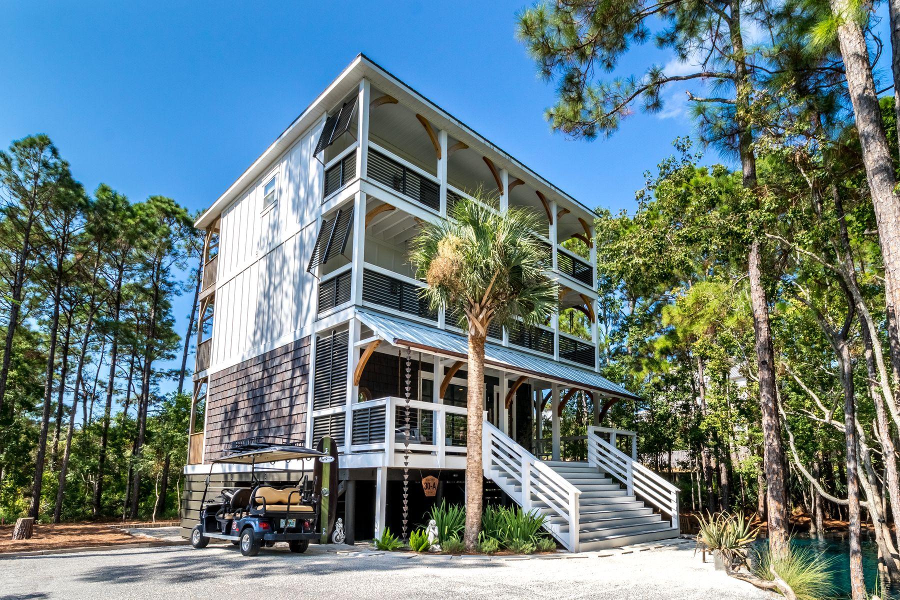 Nestled on a private wooded lot that includes a stunning natural aquifer water feature, this contemporary three story coastal home is quite unlike any other. Similar to a spring-fed lake, the surreal freshwater pool maintains the same level as the water table, providing a breathtaking water feature for attracting birds and wildlife. Sit quietly on the covered porch and enjoy the peaceful environment surrounded by native greenery. After dark, it's a wonderful place for stargazing or toasting marshmallows on the glowing fire pit.This remarkable beach house is immaculate inside and out, with timeless dcor reflecting its natural surroundings. The home takes its inspiration from the nearby beach and woodland setting with shiplap walls, rustic timber features and cedar-like shake shingle