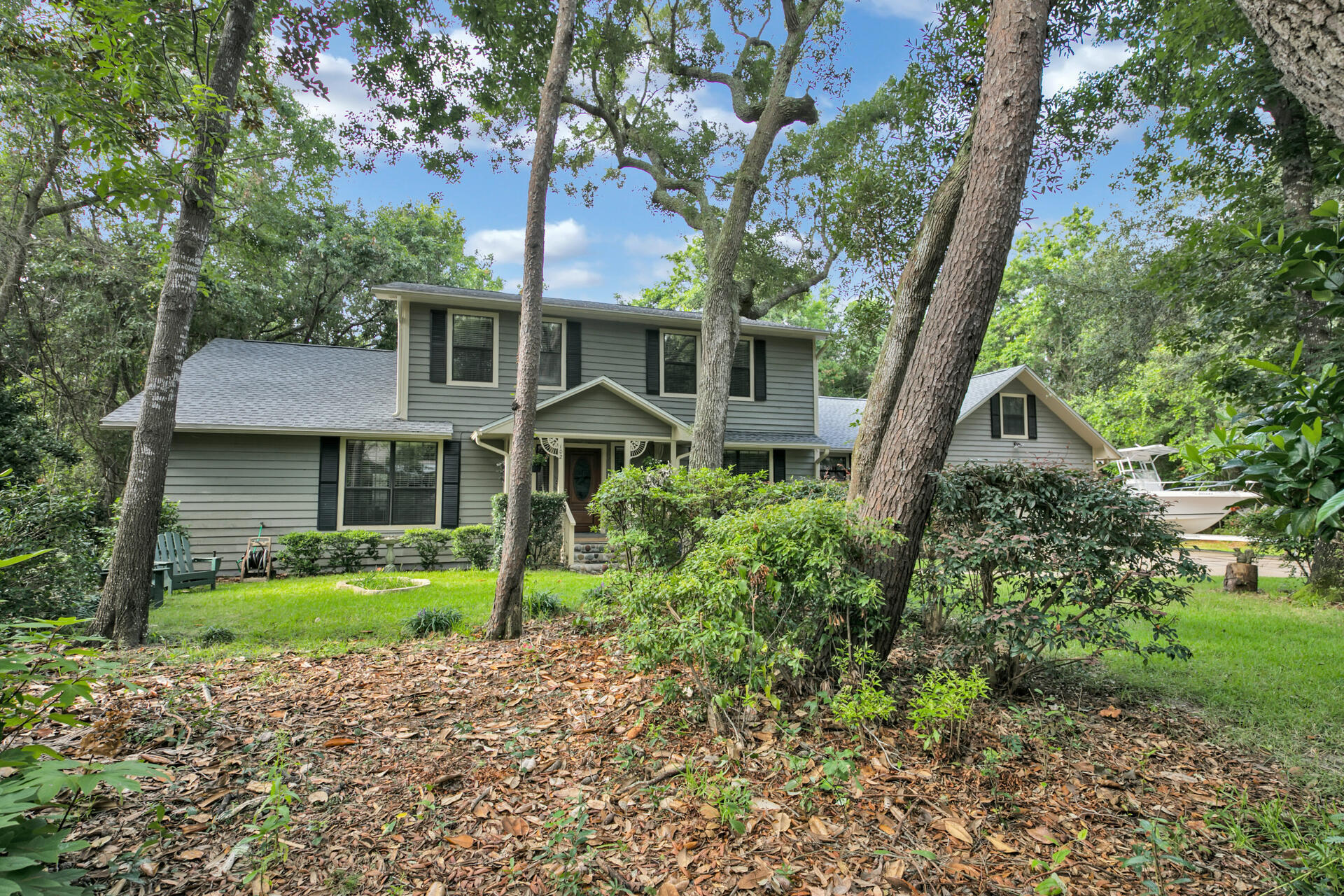 You will be impressed the minute you see this beautiful Bluewater Bay Home. The majestic oaks, elm, and magnolia trees tower over the lush landscaping. The kitchen has been recently renovated with new cabinets, backsplash, and granite countertops. The room sizes are absolutely impressive and there is an abundance of closets and extra storage. Hardwood floors are found throughout the downstairs and the living room has a wood burning fire place. Outside, you will find a screened porch and open deck to enjoy the privacy and views from your backyard. There is plenty of parking for your cars and boats. This home has been well maintained by its thoughtful owners and the roof was replaced in 2020. Schedule your exclusive showing today!
