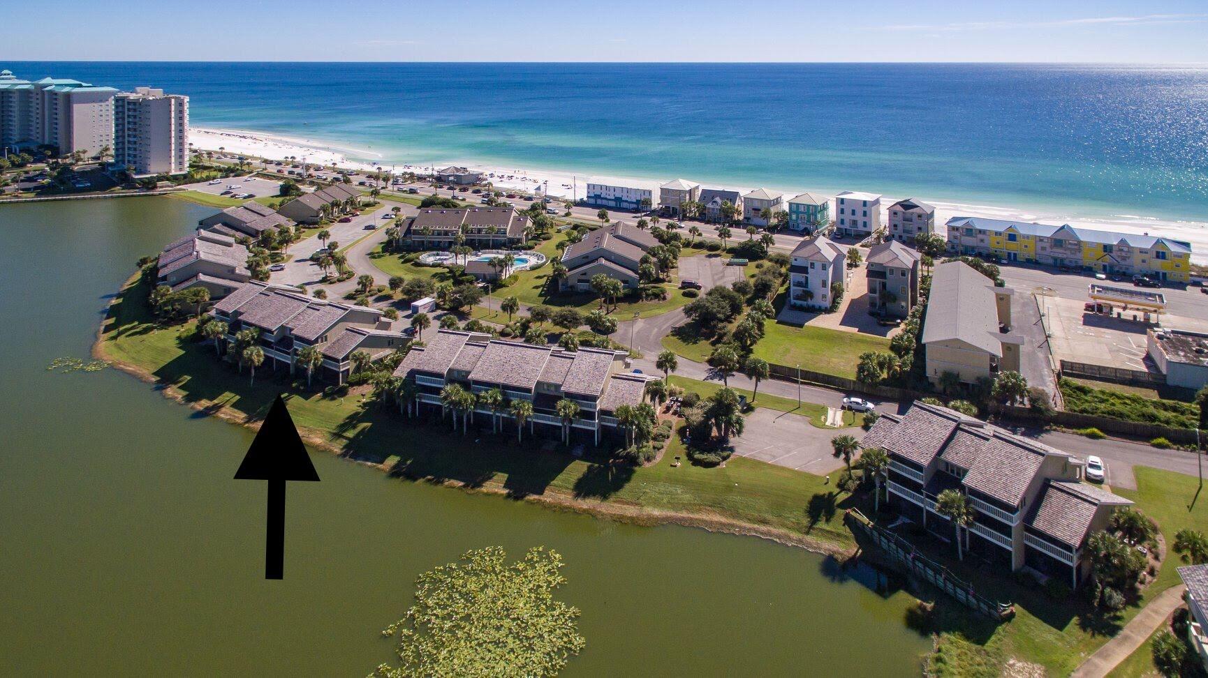 Terrific 3BR/3BA lakeview beach condo in the best location available in Seascape Resort.  25 steps to heated pool (one of five available), and about 75 to beach access.  Large, open design with expansive views of lake and golf course from living area and MBR.  All three bedrooms have attached full baths.  Currently set up to sleep 7 comfortably (K,Q,Q,T).  Kitchen has stainless appliances, granite countertops, and breakfast bar. Condo was renovated in '21/'22, including a new HVAC system.  LVP flooring throughout. Exterior of building completely rebuilt by HOA in 2024, with new hurricane rated windows, doors, decks, and 50-year Hardie-Plank  siding, complying with new Florida structural standards.