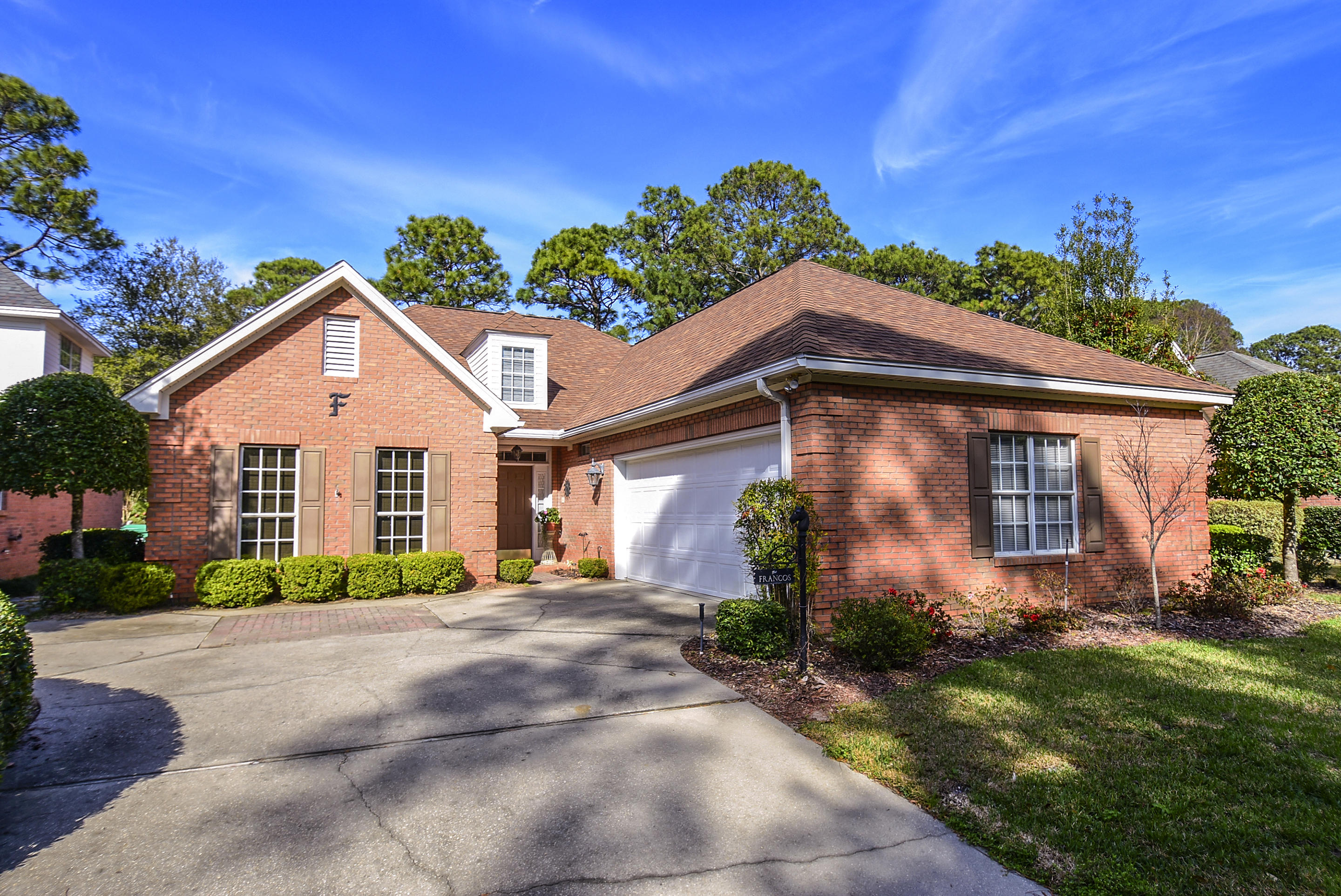 Tasteful and stylish is this 4 bedroom, 2 bath all brick, one-level home that was built to capture comfort and easy living. Many gracious upgrades are immediately noticed when entering. Keeping true to southern tradition, features include smooth ceilings, deep crown and base molding, wood encased windows and a fireplace. Thoughtful planning and professional design by Chateau Builders and upgrades by owners include split bedroom floor plan, open living area concept, walls of windows, wood plank flooring, custom window treatments, granite and stainless appliances. The back yard is a garden to be enjoyed on the large tiled patio ~ panoramic views of the golf course which also provides privacy.Roof replaced 2014. Don't forget the short drive to beaches, dining, bases & hospitals. See