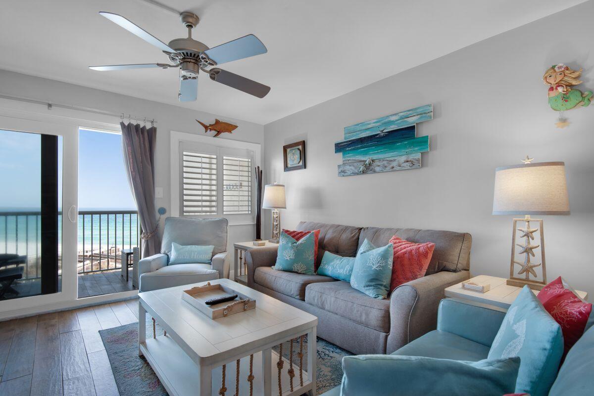 This updated fourth-floor condo enjoys panoramic gulf and beach views from the living room and covered balcony. Stylish wood-tile floors flow through the open floor plan, which includes a designated dining area and a neat bar with beverage/wine fridge for entertaining. The updated kitchen has stainless appliances, beautiful granite countertops and a decorative tile backsplash. Perch on stools for cocktails and snacks at the breakfast bar before dining alfresco on the balcony accompanied by the sounds of the sea. The sitting area in the living room shares the same unobstructed beach and gulf views and there's ample space to accommodate additional guests on a sleeper sofa. Coastal-inspired decor adds a fresh clean look to this beautiful beach condo. The generous gulf-view master boasts a