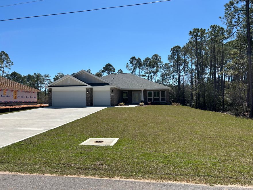* New in Navarre * 2'x6' Exterior Construction * 3 Car Garage * 1/2 acre (.46 acres) * Open Concept Split Bedroom 4BR/3BA + Flex Rm & Morning Rm * Click n Lock Laminate Wood Plank Flooring Throughout * Tile Flooring & Granite Countertops in All Baths * 10 Ft Flat Ceilings in Family Rm, Foyer, Dining Rm, Flex Rm, Morning Rm, Kitchen & Breakfast Cafe * Kitchen Features: Granite Countertops & Island, Stainless Steel Appliances & Walk in Pantry * Main Suite: Trey Ceiling * Main Bath: Builder's Signature Zero entry Walk in Tile Shower with 2 Shower Heads, Tile Floor, Double VanIty, Separate Soaking Tub & 2 Walk-in Closets * Ceiling Fans in Family Rm, All Bedrooms & Covered Rear Lanai * Covered Entry * Irrigation, Lawn Pump & Well in Sodded Areas * Builder & Structural Warranty *
