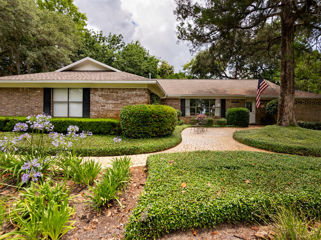 Located in the desirable community of Lido Village and positioned perfectly on a .50 acre lot, this all brick home has plenty of living space and lots of windows allowing you to enjoy the beautiful views of your peaceful, park like front and backyard. This home has been meticulously maintained. The roof was replaced in 2017, attic insulated in 2014, windows and doors replaced in Florida room in 2012, bathrooms remodeled and new AC in 2011. There is a full termite bond in place for peace of mind. The living area and formal dining room are open to one another. On the back of the house is a large eat-in kitchen that is open to the family room and overlooks the backyard. There is also a spacious heated and cooled Florida Room. The master bedroom has two closets, one of which is 11x13!