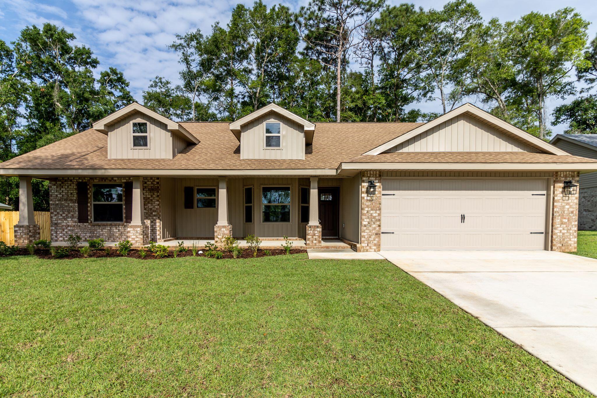 Dont let the sq footage of this house fool you! This 3/2 has a large living room with cathedral ceiling.The kitchen overlooks the living room and has alot of counter space all granite. Ther is alot of natural light coming in as the living room has 3 windows and a door leading out onto the 10' x 20' covered back porch. The front porch will not disappoint you! This craftsman style offers a very large covered porch. The kitchen area has an attractive bay window and a cathedral ceiling as well. This is a split bedroom plan and the master bath comes with a garden tub and walk in shower. Floors have been upgraded with durable LVP and bedrooms are carpeted. This home sits on a corner lot that is fully sodded, professionally landscaped and has sprrinklers front and back.