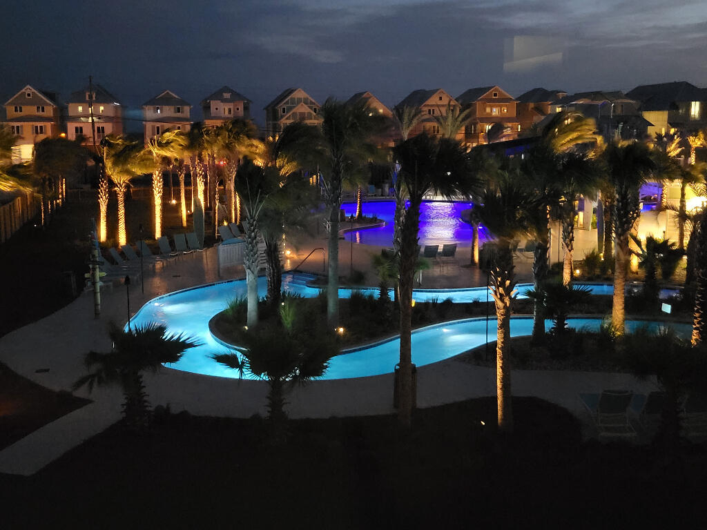 New construction. Never rented. Just 2 miles east of Pier Park with gulf views from this two story home. This property is turnkey with furniture, linens, and a well-equipped kitchen, complete with a margaritaville machine to enjoy a 5:00 always experience. All bedrooms are en-suite. The 12-person capacity with two king and three queen bedrooms, along with a queen sleeper sofa will optimize rental income. This home also has an EV car charger. Just steps out your back door you can enjoy a cheeseburger and margarita, available poolside, while relaxing in the 2.5-acre heated resort pool with waterslides and a lazy river. Or walk to the 580 feet of dedicated beachfront with beach chairs and paddleboards available to resort guests and owners only. Future amenities include a fitness center,