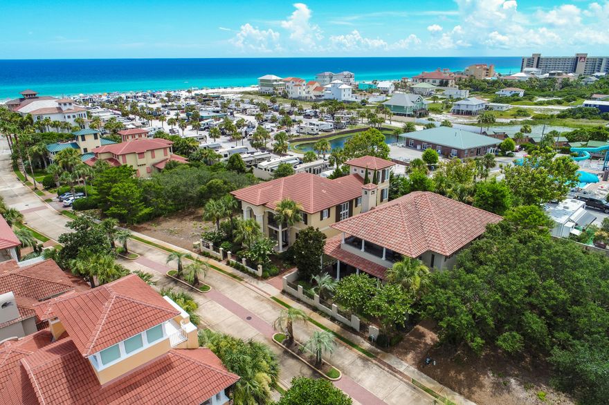 Beautiful, meticulously maintained home inside the gated Neighborhood of Caribe. This is an extremely well built home designed by Carey McWhorter and hand crafted by Jerome Wilkerson. Quality of this home is unmatched, traditional stucco OVER CONCRETE BLOCK, soaring ceiling at entrance, 1st floor master, leaded glass, high elevated homesite, and a large wrap around porch with fireplace are only a few outstanding features. Caribe is gated, security, two community pools, tennis court, and deeded beach access only steps away. This home is extremely well built and is perfect for someone looking for quality.