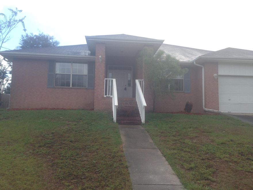 This large all-brick home high on the hill has been refreshed and renewed with brand-new carpets and new neutral-toned paint throughout. Tall brick columns flank the covered front porch. Just beside the two-car garage is an extra parking pad perfect for an RV or boat. Laminate wood flooring in the entryway continues into the living room with high vaulted ceilings, fireplace, and a tall plant ledge. The tiled kitchen with breakfast bar is fully open to the living room making entertaining a breeze. The master suite features his and hers bathrooms, one with a garden tub and one with a shower. Both bathrooms offer walk-in closets. Just through the back door is a nice-sized patio great for grilling and a backyard that is partially privacy fenced. Schedule your showing today!