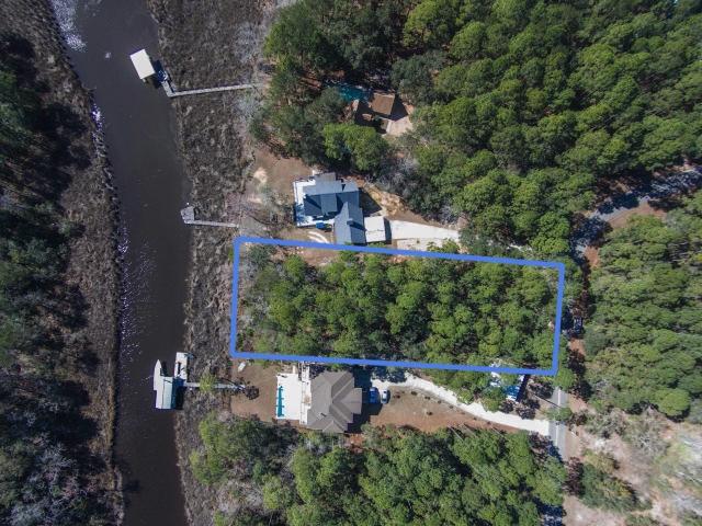Price improvement! This is a gorgeous homesite with beautiful hardwoods and palmetto palms on this level lot with approx. 92 ft. of bayou frontage that leads to LaGrange Bayou and the Choctawhatchee Bay. This lot is .71 acre and sits on a quiet road away from the congestion, but still a short distance to shopping and the beach. Don't miss this opportunity to build your dream home. All dimensions should be verified by buyer.