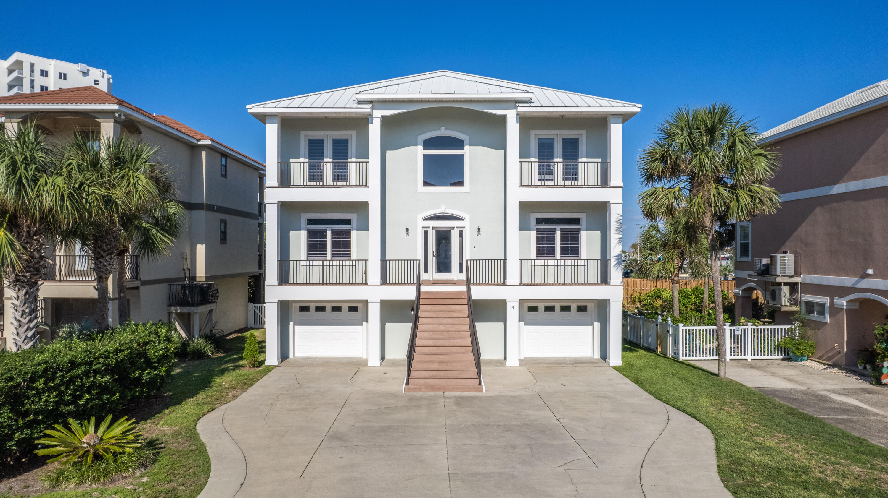 Conveniently located on Pensacola Beach in the private community of La Caribe, this gorgeous home offers an open spacious floor plan with 10 foot soaring ceilings and impact resistant doors and windows with fresh paint on both interior and exterior. Located on the ground floor, you'll enjoy an awesome climate controlled 1300+ sq ft bonus living area with a full bathroom and additional storage that is perfect for entertaining or even a pool room. With an optimal location, it's just a short walk across the street to Casino Beach (public beach access), the pier, Boardwalk and a plethora of dining and entertainment options all within walking distance. The main living floor has crown molding and travertine flooring throughout with all new tasteful light fixtures. The kitchen comes equipped with