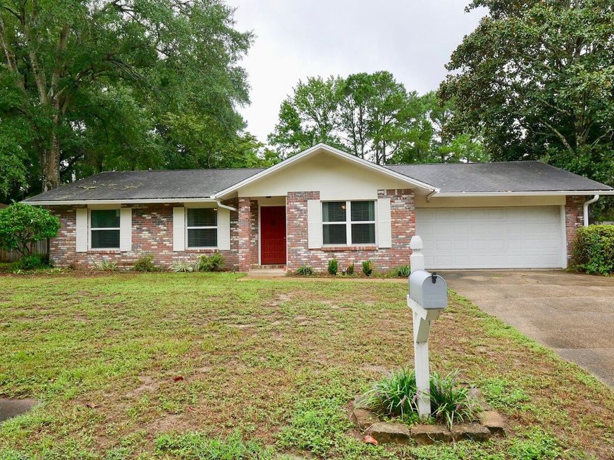 A move-in ready home with a 2-car garage (with NEWER GARAGE DOOR) located on a large corner lot in Palm Estates. This home has been nicely updated by opening up the floorplan, renovating the kitchen and installing wood laminate flooring and tile throughout. When you enter the home, the living room is on your right. Adjacent to the living room is the kitchen that is open to the great room. The kitchen has been updated with new cabinetry with under cabinet lighting, solid surface counters and stainless appliances. A large breakfast bar separates the kitchen from the oversized great room. The great room features a wood burning fireplace and new sliding glass doors leading to the screened porch. There is plenty of space for both a dining area and a living area in this large family sized room. The master bedroom has a private bath with granite counters and the two additional guest bedrooms share a full bath. The 2-car garage with a workshop area is sure to please the handy person of the family and the good sized yard offers plenty of space for children or pets. The yard is fully fenced with a privacy fence that includes a double gate. The windows were replaced with vinyl windows and according to a previous owner, the water heater was replaced in 1017, the roof was replaced in 2009 and the HVAC system was replaced in 2008.