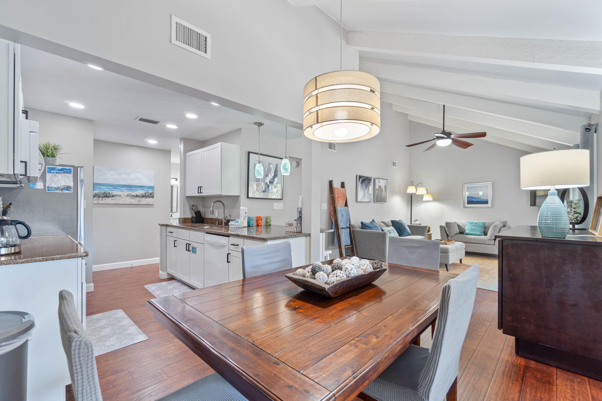 One of the nicest furnished & decorated 1 Bedroom Condos within the 300+ acre Gated Community of Seascape with 2000 feet of white sand Beach, lush greens & serene lakes. Conveniently located 50 steps from the Pickleball Courts and 1 of 5 Community Pools. Strategically positioned in a quiet private 2nd floor setting with mature trees. Relax & enjoy the warm Gulf breeze on the expansive 8' x 24' Balcony/Porch while entertaining family & guests. The tastefully decorated & remodeled unit feels new with all the interior upgrades & enhancements including wood-look flooring throughout. Stylish living area & dining area have high ceilings with white exposed wood beams & double sliding glass doors that offer natural light & views of the Porch & magnolia trees. Enjoy the tranquil setting while relaxing or dining & entertaining in the spacious living areas. A trendy Murphy Bed Cabinet hides a Queen Size mattress to accommodate overnight Guests. The adjacent Kitchen offers ample storage space with white Cabinets, granite countertops, breakfast bar, new 2024 Refrigerator, 2022 Dishwasher, Oven, Microwave & Double Sink. The inviting & fashionable Bedroom has an attractive designer wall showcasing a White King size Bed, dresser, end tables and Closet. The beautifully Remodeled Bathroom has a stunning new walk-in shower & Quartz top vanity, fixtures and an additional vanity outside the bathroom for convenience. The smart design Laundry area has added counter space, storage & a 2023 Washer/Dryer. New Roof March 2024. This location offers ample parking. Amenities include the 2000 feet of white sand Beach, 5 Pools, (2 heated), Pickleball, Tennis, kickball, basketball, Golf Course, Charcoal BBQ areas, Picnic tables and Bike & Golf Cart Rentals. Enjoy causal dining at The Whale's Tail Beach Bar & Grill directly on the Beach. Seascape Town Center has 2 Birds Coffee/Cafe, Mezcal Mexican Grill, Acme Oyster House, Ice Cream Shop, Wine & Spirits & more. Seascape hosts numerous events and functions throughout the year. Conveniently located near Silver Sands Outlet Mall, Grand Blvd Dining & Shopping, Sandestin, Sacred Heart Medical Office & Hospital & more. Primary or vacation home, long term or short term rental. Must see to appreciate! Don't miss this one!