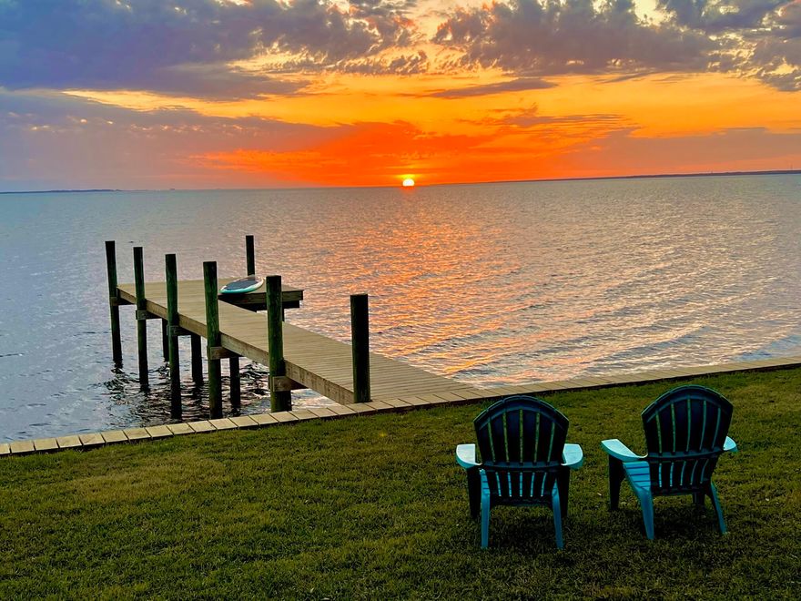 Incredible opportunity to own a beautiful, custom built home with 103 ft of Bay frontage! The home is nestled among lovely pine, oak, and magnolia trees on just under a 1/2 acre with a sandy beach along the shoreline to enjoy. Located in a serene area on a private road where nature can be enjoyed to its fullest. The already existing dock is perfect for lounging while taking in the stunning Bay views, fishing, or launching a paddle board or kayak to explore the Bay. Easily add a boat lift & take a sunset cruise right from your back yard where dolphins are often spotted. This home has been meticulously maintained & has beautiful curb appeal with well-manicured landscaping & a welcoming front porch. Parking is not an issue with a detached 2-car garage & space for 6 vehicles in the driveway.