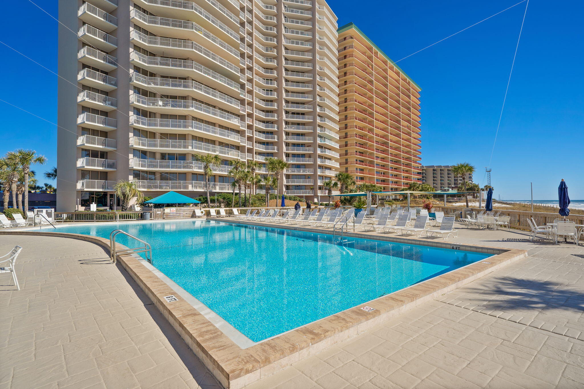 **Rare Gulf-Front Opportunity at Dunes of Panama - End Unit E206** Presenting an exceptional opportunity to own this highly sought-after 3-bedroom, 3-bathroom Gulf-front condo at Dunes of Panama! Located on a desirable lower floor, this end unit offers stunning, panoramic views of the Gulf of Mexico. The spacious layout includes two en-suite bathrooms, along with an additional dressing room for added convenience. This residence has been meticulously furnished and updated, featuring new sliding doors, front windows, and tiled floors throughout. The kitchen boasts new appliances, and every room is equipped with Smart TVs, Cable, and HD WiFi for modern comfort. Step out onto the brand-new, wood-grained tiled balcony that spans the entire length of the condo, perfect for enjoying the breathtaking views. The third bedroom also includes its own private balcony, offering more opportunities to relax in this serene setting. For added convenience and security, the sale includes a small storage unit and a deeded, covered, and gated garage parking space. The condo is offered turnkey with all furnishings and items seen in the unit, making it move-in ready. Additionally, major updates include a water heater replacement in 2019, and a new AC and handler (4 tons) in 2017. In late 2023, a Blue Tube UV Air and A/C Unit Cleaner was also installed for optimal air quality. With a rental history exceeding $75,000 annually, this property offers excellent income potential. The current owner is also open to conveying future bookings, ensuring a seamless transition for new owners. The Dunes of Panama Resort offers 1,500 linear feet of pristine, sugar-white sand and a range of amenities, including: - Three Gulf-front pools (one heated) - Tennis courts and pickleball coming soon - Basketball, volleyball, and shuffleboard courts - Fitness room - Free Wi-Fi, outdoor BBQ grills, and Stingray's restaurant & gift shop - The Sneaky Tiki poolside bar. Don't miss the chance to own this updated, well-maintained piece of paradise in the desirable Dunes of Panama. Schedule your viewing today and experience the best of Gulf-front living!
