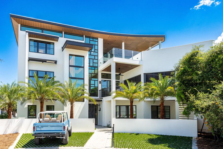 Welcome to 33 Camp Creek Point, an architectural masterpiece that perfectly blends modern luxury with coastal elegance. Spanning 6,800 square feet, this stunning 5-bedroom, 6 full bath, and 2 half bath residence showcases unparalleled craftsmanship and thoughtfully curated design throughout, delivering a one-of-a-kind living experience along Florida's iconic 30A.At the heart of the home is a breathtaking three-story floating staircase, dramatically wrapped around a glowing wall of lighted Amberlite. This sculptural centerpiece anchors all levels of the home and sets the tone for its bold, contemporary aesthetic. A three-story Mondrian-style glass wall enhances the vertical space with light and movement, while clean architectural lines, expansive windows, and minimalist detailing create an atmosphere of openness and sophistication. The striking Parklex Prodema ceiling and soffit flow seamlessly from interior to exterior, reinforcing the home's deep connection to its natural surroundings and commitment to indoor-outdoor living.

The second floor is anchored by a state-of-the-art gourmet kitchen, outfitted with Wolf and Sub-Zero appliances, custom cabinetry, and an oversized waterfall islandideal for casual dining or entertaining on a grand scale. The kitchen flows effortlessly into expansive living and dining areas framed by floor-to-ceiling glass, opening to generous balconies and blurring the boundaries between interior comfort and outdoor beauty.

The third-floor recreation area offers a showstopping rooftop retreat, opening directly onto a private resort-style pool deck with panoramic views of the Gulf. On the opposite side, a spacious patio with a fully equipped outdoor kitchen overlooks the tranquil waters of Camp Creek Lake. These rare dual waterfront vistas create a truly unique and elevated coastal living experience and are the focal point of the more than 2000 square feet of outdoor living area.

The primary suite is a private sanctuary, thoughtfully positioned for maximum privacy and natural light. It features a spa-inspired master bath with a soaking tub, oversized glass shower, and dual vanities with elegant custom finishes. A spacious walk-in closet completes the suite with style and functionality.

Adding to the home's bespoke features is a custom climate-controlled wine room, artfully designed with architectural shelving and dramatic display lightingperfect for collectors and entertainers alike.

Set within the exclusive gated community of Camp Creek Point, this home offers both privacy and security, along with deeded access to the sugar-white sands of the Gulf and the serene waters of Camp Creek Lake. Whether you're seeking a peaceful coastal retreat or a bold architectural statement for entertaining and living well, 33 Camp Creek Point delivers the ultimate in modern design, luxury, and lifestyle.







