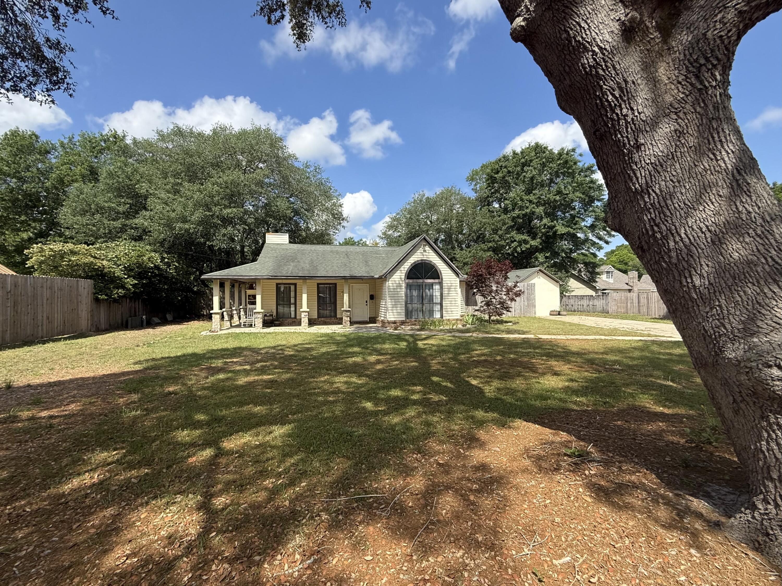 With approx 1/2 acre, this 3 bdrm, 2 bath home is south of Crestview in the county. Completely fenced-in, large back yard with mature live oak trees on a cul-de-sac. There is a small shed to store lawn tools, a 12 x 24 building that has a window a/c unit that was converted from a 1-car garage. Many upgrades theist fee years include: roof replaced in 2018, new septic in 2019, HVAC in 2017 and new vinyl flooring installed in 2018. The master bathroom was updated in 2024 w tile flooring, vanity with granite top & tub insert. Enjoy the wood burning fireplace in the living room during the cool winter evenings. In the galley kitchen, all stainless steel appliances with a new dishwasher replaced in 2023. Buyer(s) are responsible to personally verify all details for property and dimensions. Any information contained in this listing is believed to be accurate but is not guaranteed.