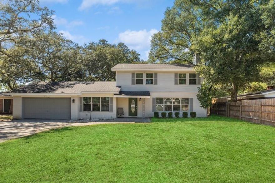 Seller offering introductory rate 2% below current market first year, 1% second year. Welcome to this charming four-bedroom, three-bathroom traditional-style home with a very large back yard! As you drive up the brick driveway, you'll be greeted by an inviting entrance. The center entrance provides seamless access to the entire updated home without unnecessary traffic through other rooms.Inside, you'll find a spacious dining room perfect for family gatherings and an updated kitchen featuring granite countertops. The cozy living area boasts a fireplace, perfect for chilly evenings. The home is adorned with beautiful wood flooring and ceiling fans throughout. Large windows flood the space with natural light, and the bathrooms are modern and stylish. Step outside to discover a really large backyard, perfect for outdoor activities and entertaining. This home is a true gem, combining comfort and 