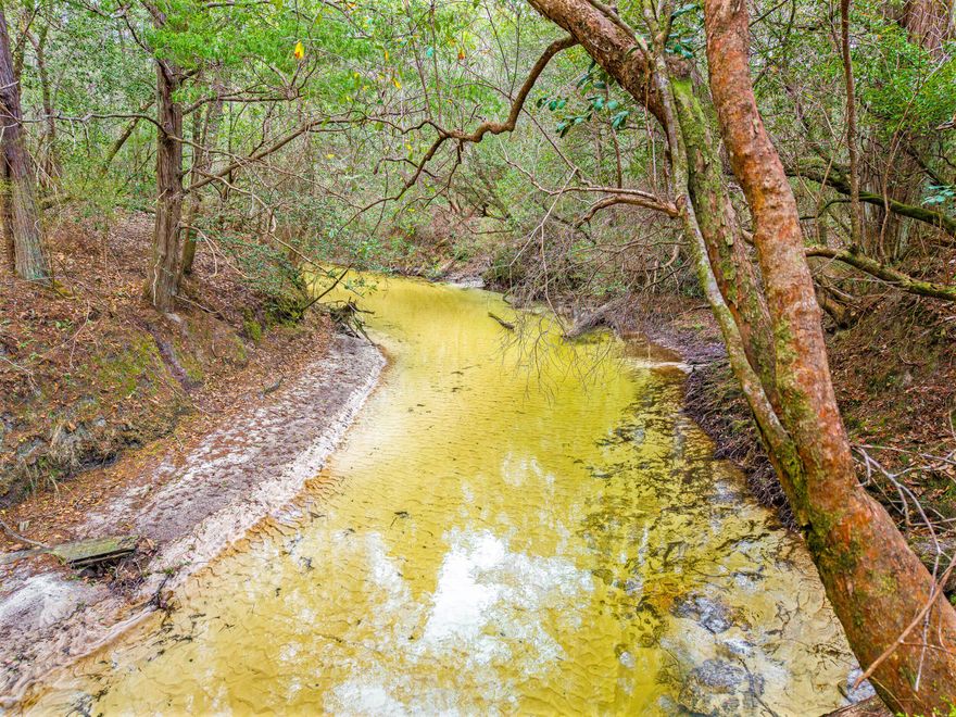 Discover your perfect escape on this 80.5-acre property featuring a year-round creek, power already on-site, and a well-built 24' x 36' pole barn with a 12' x 12' enclosed utility room. Whether you're looking for a peaceful recreational retreat, a hobby farm, or a homestead site, this property is ready and waiting for your vision. Imagine driving up a newly asphalt milled driveway to your very own 80.5 acres of beautiful, diverse terrain with open area, lush area of trees and a Creek, ideal for recreation, wildlife, or simply relaxing to the sound of flowing water. Abundant wildlife and excellent hunting and already has established food plots. There is also space for hiking and/or ATV riding opportunities. Plenty of flat and gently rolling land suitable for building your dream home or cabin This rare find offers privacy, versatility, and natural beauty. Don't miss out. 
