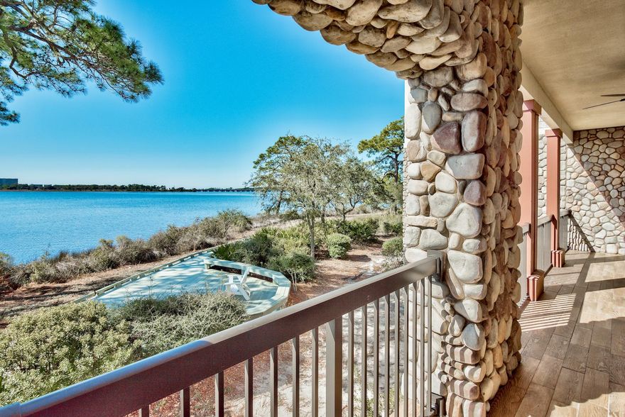 Priced to sell!!! Water Views and Sunsets with a totally private balcony to enjoy them on! This beautifully decorated corner unit is move in ready! Just hang your clothes in the closet and head to the beach or put your kayak or paddle board in Lake Powell and begin to enjoy life here. Dock is right outside your door. Wild Heron has many amenities to enjoy - 2 swimming pools, fitness center, tennis courts, outdoor fire pit, barbecue, picnic area with 24 guarded and gated security. The fabulous Greg Norman designed Sharks Tooth Golf Course and Club is located here for those who wish to join this Private Club. Only minutes from the gulf and the 30A communities of Rosemary and Alys Beach, the unit is ready for immediate occupancy. Seller will provide a 1-year Home Warranty