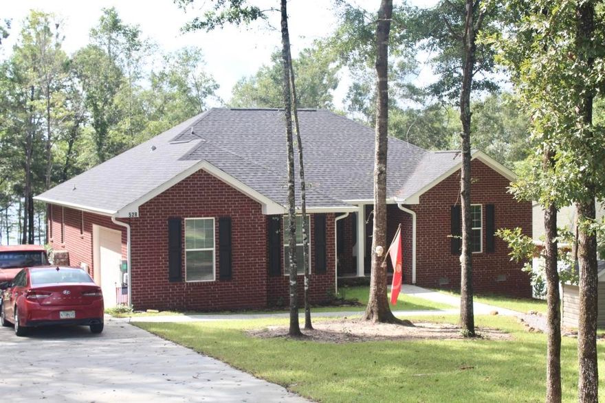 MOTIVATED SELLER! Must see this ''like new'' 2017 custom built brick waterfront home on pristine Blue Pond, one of N. Florida's natural spring fed lakes. Swim, snorkel, scuba dive or fish. The ''like new'' 2017 brick home is custom designed and features a split floor plan, formal dining area, custom kitchen with stainless steel appliances that includes a gas stove, breakfast bar and breakfast nook. The master suite has his & hers walk in closets, double vanity, over sized tub and detached shower. House includes an attached garage. Custom landscaping with french drains. House design offers plenty of windows, lots of light and beautiful views of the lake. New home warranty in place. Hurricane shudders included. Adjoining buildable lot also available. Shown by Appt.