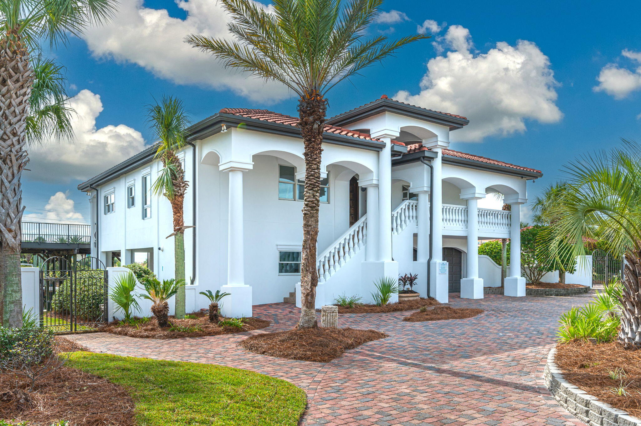 BOATERS DELIGHT -- ''Vista Marina'' is the quintessence of waterfront living and boating, with approximately 217 feet of deep water (with a 160 ft boardwalk) and an inlet cut with two COVERED boat slips (18' and 28' respectively). This NEWLY RENOVATED home offers all the features you would expect in a coastal home with beautiful views of the Gulf. The home was designed to accommodate large gatherings with plenty of outdoor space for fun-filled activities along the canal/boardwalk, in the pool area, the outdoor kitchen area or the dual-use travertine, covered patio. Too many amazing features to list.  Seller has priced fairly for a quick sale. A must see in person!