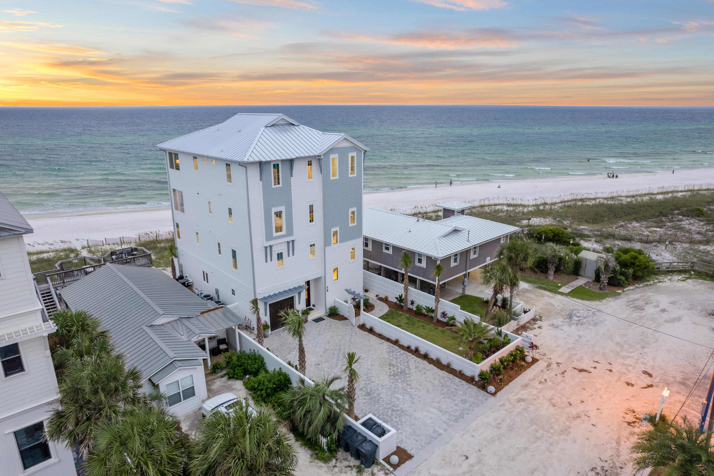 BRAND NEW Gulfront masterpiece you don't want to miss! 74 S Emerald Cove is beach living at its finest. 49 feet of private deeded beach access located in the exclusive area of Inlet Beach.This four story luxury home was custom built  with every inch thoughtfully designed to maximize the indoor and outdoor living experience. Fully equipped residence with floor to ceiling windows and private decks on every level. This beach home has it all; two large gourmet kitchens, beautiful quartz countertops, custom cabinetry, professional sound systems on multiple levels of the home, security system, designer decor and luxury fixtures.