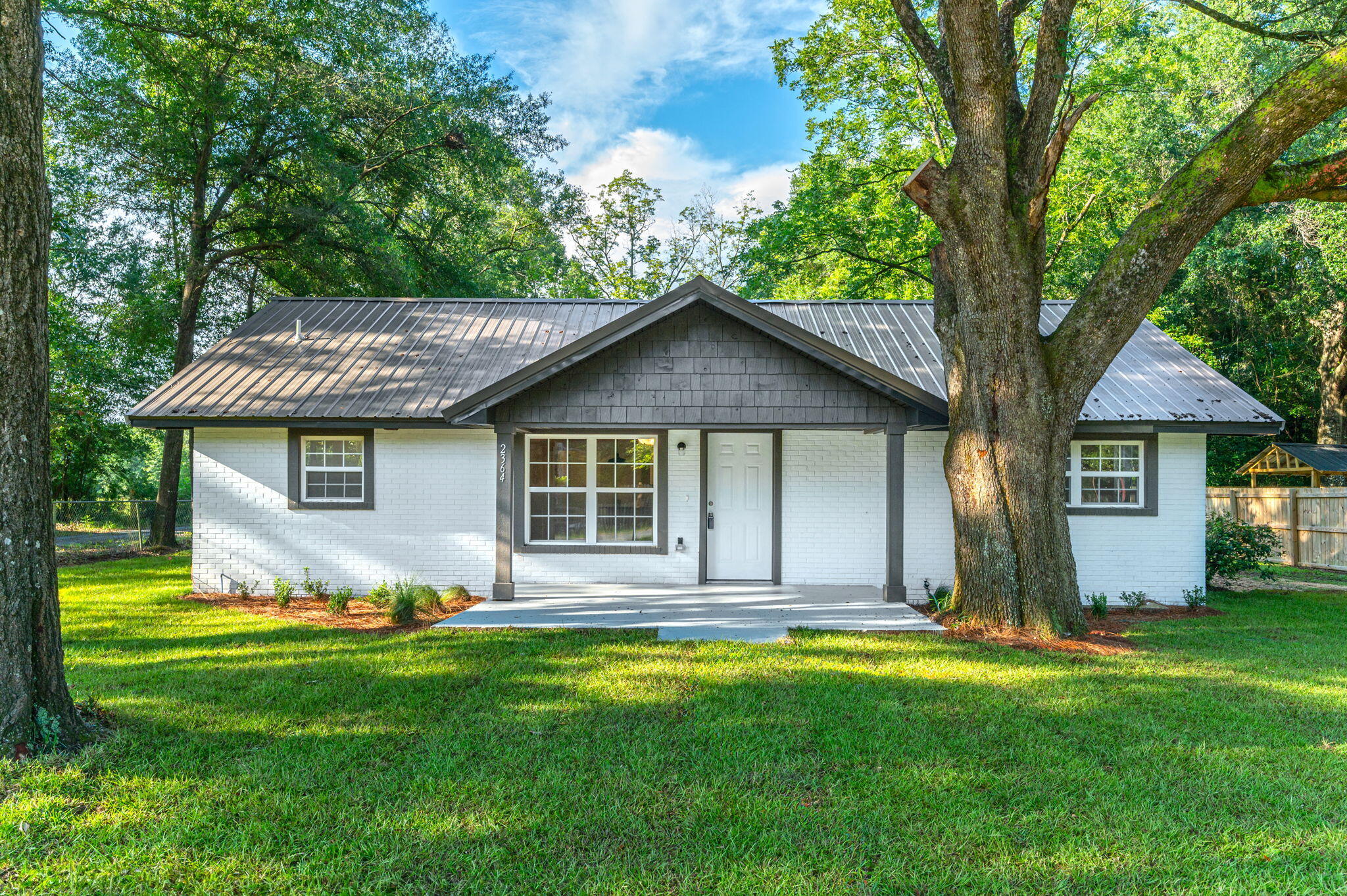 SELLERS IS OFFERING TO PAY A PORTION OF BUYERS CLOSING COST ON THIS EXTENSIVELY RENOVATED PROPERTY! Featuring just under 1600 square feet of living space, this affordable residence boasts an array of notable upgrades, including newly installed windows, cabinets, LVP flooring throughout, and granite countertops. A breakfast bar facilitates efficient meal preparation, while a separate dining room provides an ideal setting for family gatherings. The office/den is distinguished by a fireplace and expansive glass door, allowing for an abundance of natural light. The front yard showcases newly installed sod, complemented by majestic old oak trees offering exceptional shade. We invite you to schedule a viewing and explore the benefits of this exceptional property.