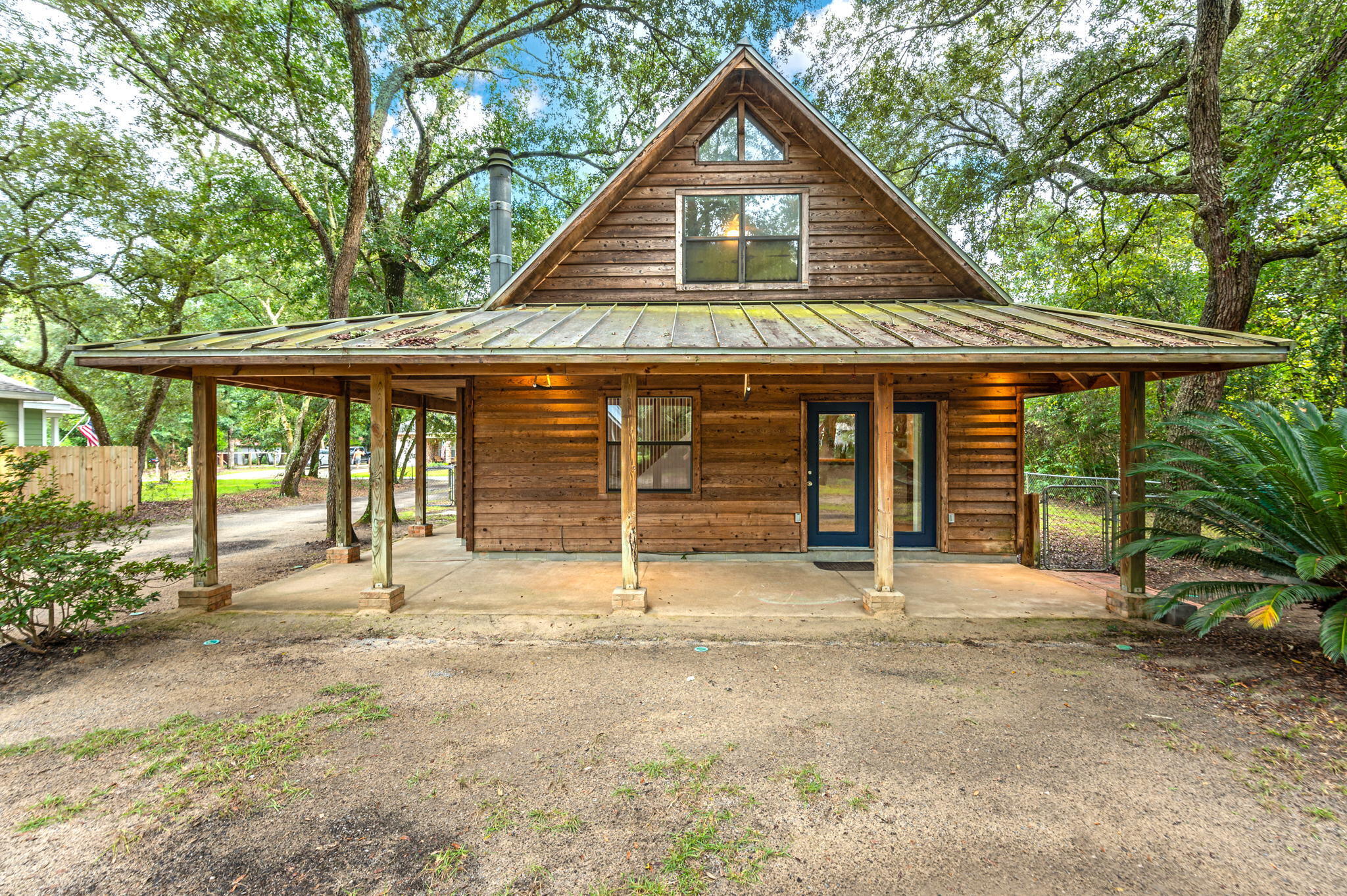 This rustic gem nestled in Choctaw Beach is waiting for you to make it your home! Front covered porch says ''bring your rocking chairs''.  The living room features a lovely fireplace with beautiful wrap around hearth.  Kitchen boasts wood cabinets with lots of storage along with a breakfast bar.  Master bedroom is on the first floor along with laundry room.  Upstairs, the additional bedrooms and bath are in a loft setting with it's own private balcony.  Have Hobbies? Need work space? The detached workshop/garage is awesome with approx. 1500 sq ft of space for you to fill! There are 2 levels to this workshop, equipt with electric and water too. Home is being sold ''AS IS''.  Don't put off viewing this one!