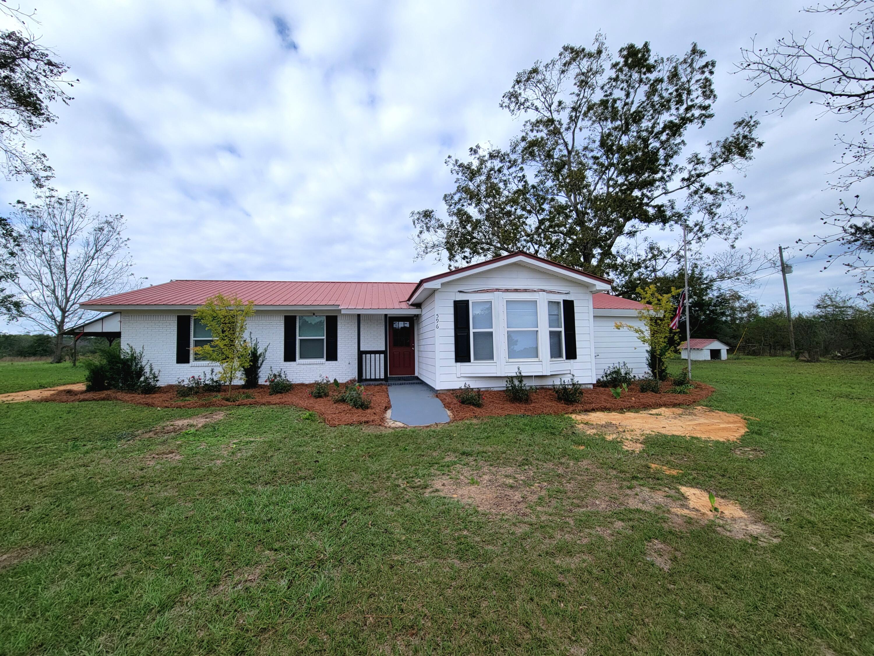 Brick country home with metal roof, new windows with 5 acres just north of DeFuniak Springs.  (Other adjoining acreage available). This home has been totally updated with new floors, freshly painted walls, 4 bedrooms- (two master bedrooms)  3 bathrooms   Beautiful new kitchen with granite countertops, new appliances included.  It feels like ''home'' when you walk with a light airy feeling with all the window light.  It has a large pecan bearing tree in the front yard), a storage building, and deep well, and a pole barn.  You can sit on your back porch and watch the sun go down each evening.  Perfect for horses or other livestock.  Easy to see, call today.