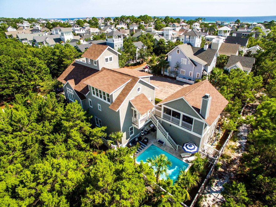 This custom designed residence inWaterSoundBeach is sure to impress. Located on an oversized homesite that backs up to the conservation area of Deer Lake State Park & fronts Puttering Park there is a tremendous amount of privacy. The impressive outside retreat is complete with an enormous heated pool, summer kitchen & plenty of room for entertaining.The interior selections are a refined sophistication evident throughout the property.One immediately appreciates the skillful millwork in the walls, trim, pecky cypress doors & cabinetry.There is a spacious master ensuite on the first floor & three additional guest bedrooms with ensuites that all exude a perfect beach vibe with a calming coastal palette.A sand room & laundry complete this level. Head upstairs & find the open kitchen, dining & living areas complete with pecky cypress ceilings.  The gourmet kitchen does not disappoint with all of the highest end accoutrements including Thermador appliances & large breakfast island.  There is an abundance of natural light streaming through the windows & doors off the covered porch which is spacious enough for both eating & relaxing.  A second master suite & powder bath are also on the second floor.  A wet bar including wine refrigerator, sink, ice maker & double drawer dishwasher service one of the most creative & useful outdoor living spaces in the community. This screened gathering spot is the perfect place to sit & unwind, enjoy the custom outdoor fireplace or play a game of ping-pong.  Head upstairs to the third level to watch a movie, play a game of pool or indoor shuffle board & much more.  Another guest bedroom with two queen beds & full bathroom complete the third story.  On the top floor is the impressive tower where the oversized deck allows everyone to enjoy the Gulf of Mexico views. Other special features of this home include carrara marble, glass tile, dumb waiter, built-in speakers throughout & two car garage. This spectacular beach compound exudes a relaxed ambience which is unique & refreshing! 
