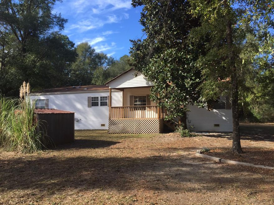 This Skyline 2007 manufactured home is spacious with lots of cabinets and center island in the kitchen. Split floorpan with master bedroom with walk-in closet, double vanity, garden tub and upgraded tiled separate shower. Carpet in all bedrooms and vinyl flooring in the kitchen, laundry and bathrooms. Appliances include a refrigerator, stove/cooktop, dishwasher and microwave. Plenty of countertop space. Outside has two outbuildings in the back and one in the front. There is a covered open space in the back. Front porch is open with covered roof.