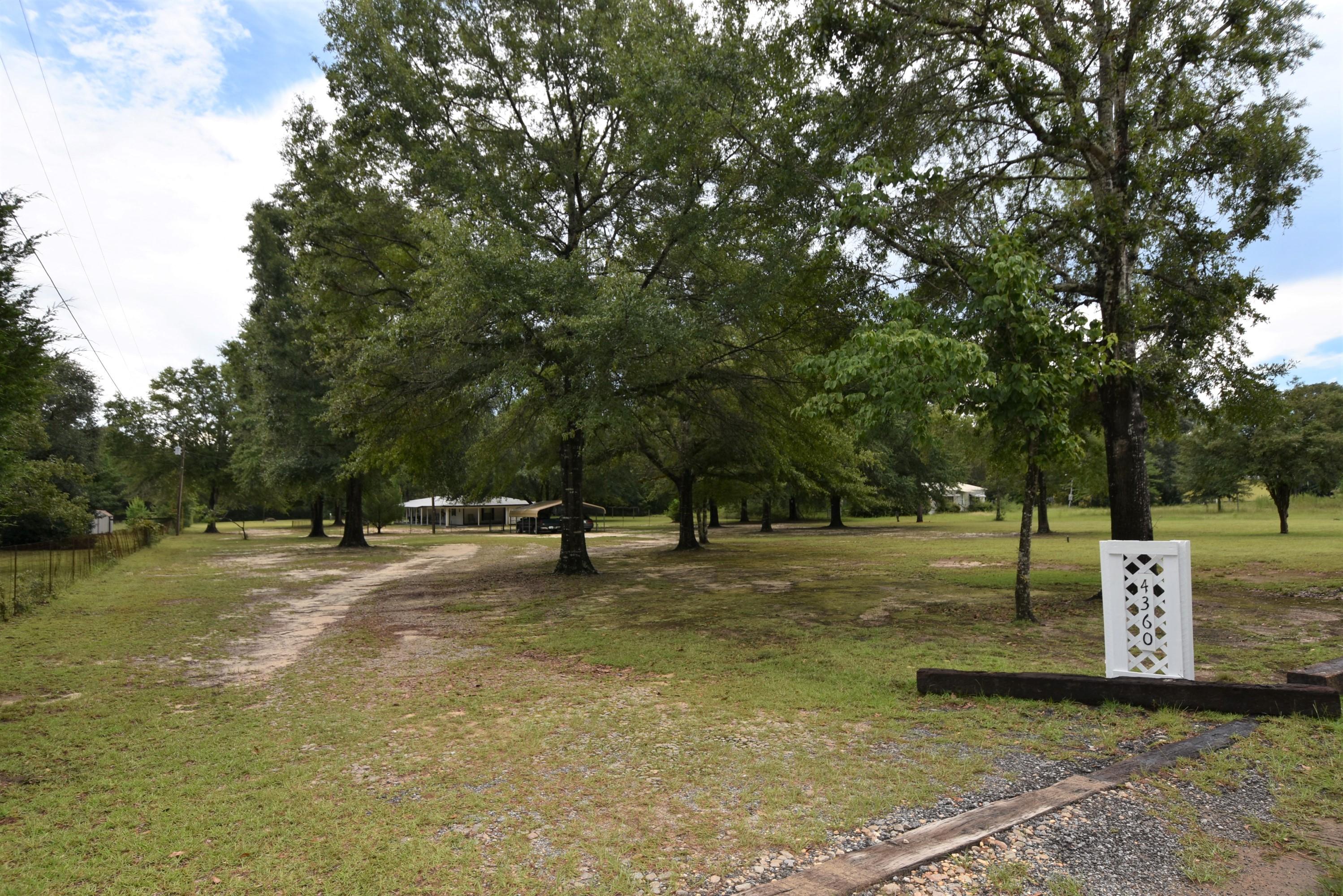 Wait for it...do you hear that? PEACE and QUITE on your level 2.5 +/- Acres with a workshop, and 1,100+ sq.ft. home featuring a wrap around porch. Meticulously maintained mobile home has updated the Roof in 2014, Heat in 2015, A/C in 2012, and Water Heater in 2008. If you enjoy the outdoors and want a few acres to call your own, then schedule your private viewing. Low traffic and less than 15 minutes to town. Convenient to Hwy 393 and Hwy 285 with easy access to I-10 Mossy Head exit. Home features 2 Bedrooms, 2 Full Bathrooms, Living Room, and a Den. Upgraded wood kitchen cabinets. Workshop with electric and work bench is ready for you and your hobbies. Information taken from public sites; Buyer to verify all information.