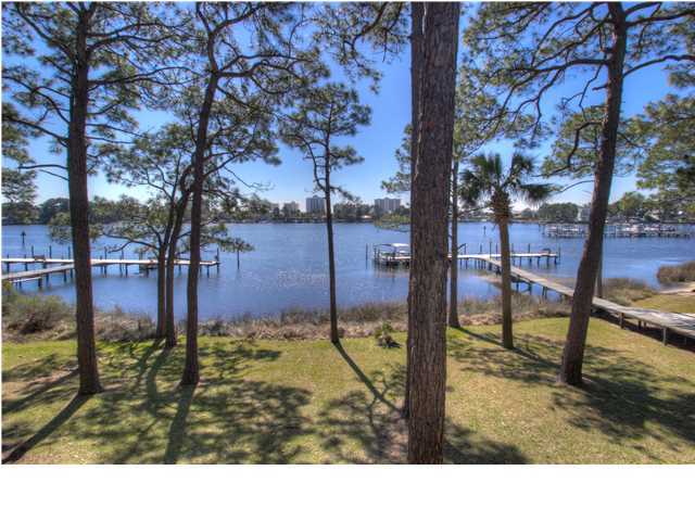 Short sale directly on the lagoon with lovely water views! This second floor condo in Grand Lagoon Cove needs work, but is in a great location. From your unit, you can see the gorgeous restful water, boats, community dock and buildings across the lagoon. The lovely treed grounds offer community pool and tennis! Nearby, you'll find fantastic shopping, dining and the beach! Buyer to verify all data. Square footage source Bay County public website. Buyer to rely solely on own appraisal for square footage and own survey for lot size.