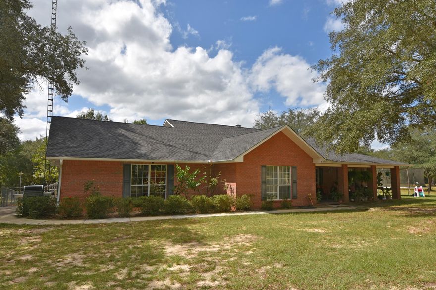 9+ ACRES, Mature Oaks, Chicken Coop, Workshop, ATV Trails, Covered RV parking, Guest House, Fire Pit, Playground and Much MORE w/your 2,466+ sq.ft. BRICK home! Great location North of the I-10 Exit at Hwy 285. Enjoy quite country living w/a beautifully updated home. Updates completed in 2015 include: main house and guest house roof, flooring, appliances, kitchen counters, and security system. Inviting Front Porch perfect to enjoy your wooded view! Step into the home w/ Formal Dining to the left and Formal Living/Den to the Right. Living Room is anchored w/a stone wood-burning fireplace and built in shelving and cabinetry. Sun Room is located off the Living Room and currently used as an office space; access to Deck. Kitchen is fully equipped w/stainless appliances, granite counters, pantry,