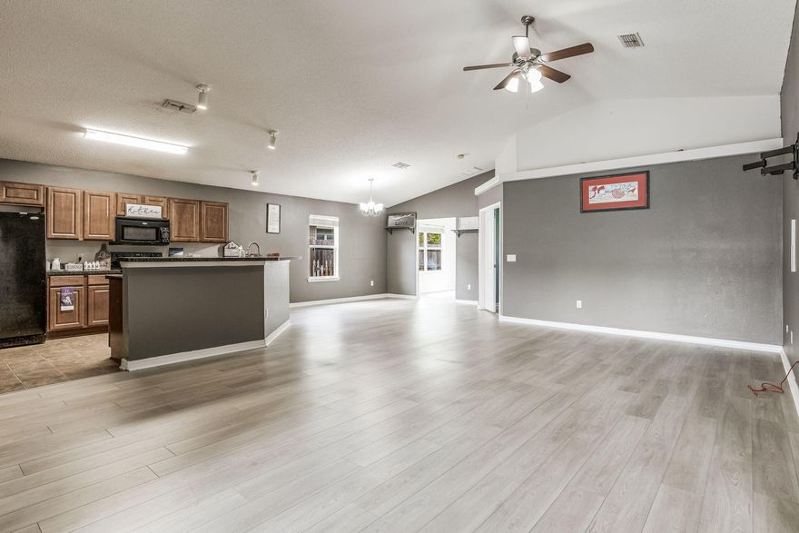 NEW LOWER PRICE AND a VA Assumable Loan at 2.875% interest rate for to qualified buyers PLUS $7200 towards closing costs!If you are searching for a large home in a quiet, family-friendly neighborhood with NO HOA, close to local schools and the beach, you just may have found it! With recent upgrades including 2021 HVAC, Roof and 2022 Solar Panels, plus new paint and new Luxury Vinyl Plank floors in the bedrooms; this spacious, open concept home has over 2000 sqft and a split bedroom floor plan. Featuring 3 large bedrooms plus a bonus sunroom/office/playroom and a huge Great Room which has soaring vaulted ceilings and tons of rooms for family and guests to mix and mingle,  The Kitchen overlooks the Living Area with a full length breakfast bar, walk-in Pantry and lots of counter space The newly decorated Master bedroom has a double door entry & it's own access to the Sunroom. Need to escape? Pamper yourself in the master bathroom with a Walk-in Shower, Garden Tub, Double Vanity, separate WC and extra large Walk-in Closet, or relax on the patio in the fully fenced back yard with sprinkler system. The fully paid off, Vivint Smart security system conveys including: interior/exterior cameras, doorbell, Thermostat, smart lock and window sensors for added security and protection. This fabulous family home is situated less than 5 minutes to the beach, with shops & dining nearby, in close proximity to local Schools, and within easy reach of Military bases.